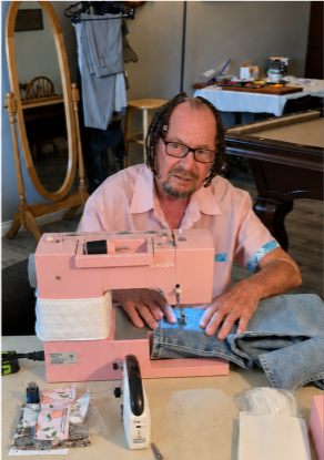 Bullock modifying pants at sewing machine